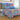 Colorful butterfly-themed bedspread on a bed with pillows.